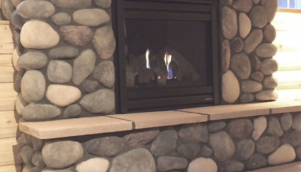 cabin living boulder fireplace
